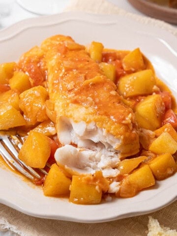 bowl of hake with cider with a fork.