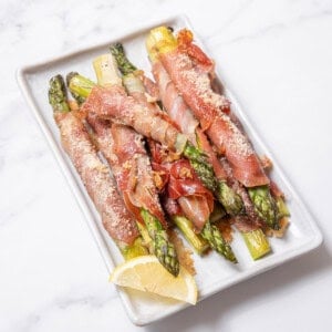 plate of roasted asparagus with ham.