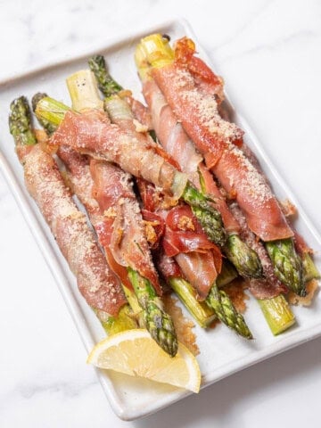 plate of roasted asparagus with ham.