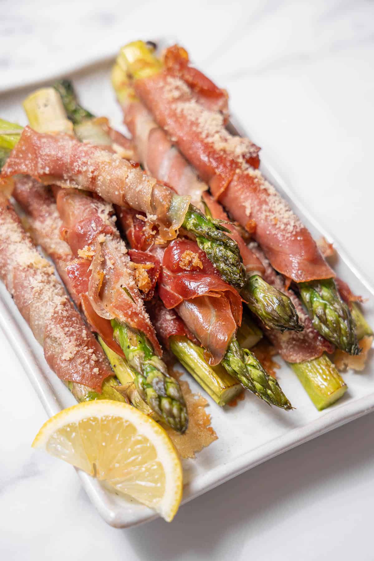 plate of roasted asparagus wrapped in ham.