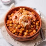 bowl of shrimp and chickpeas with a spoon.