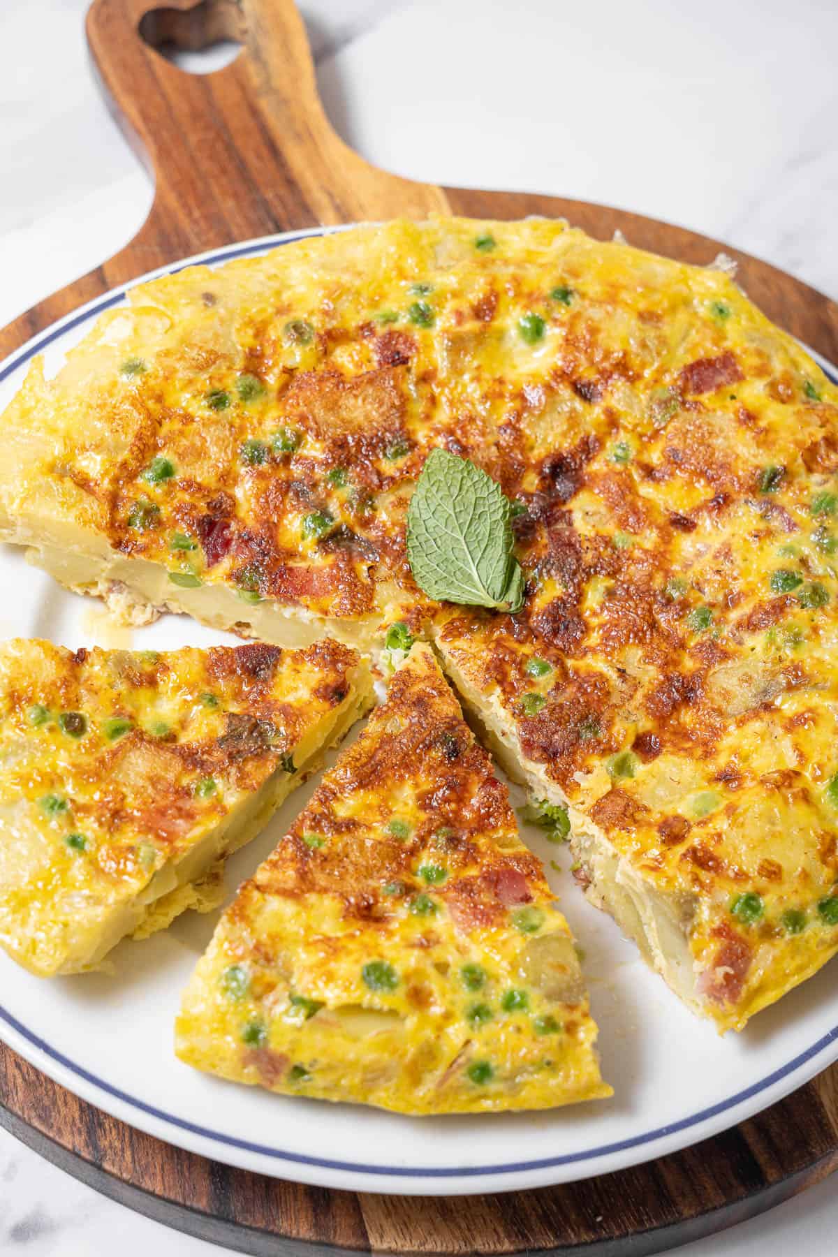 tortilla with ham and peas on a plate.