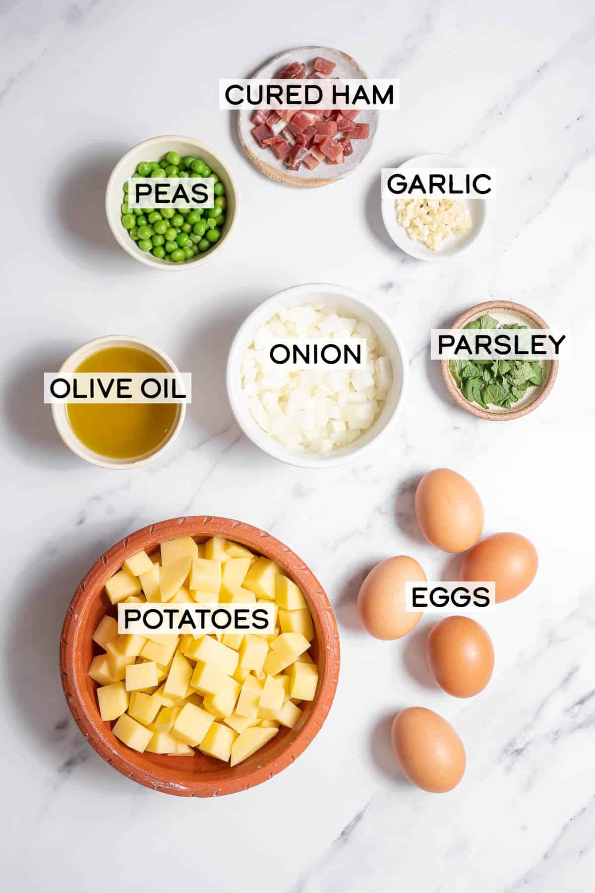 bowls of ingredients for tortilla with ham and peas.