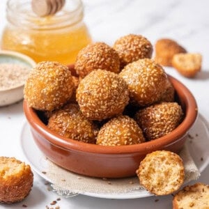 bowl of cheese puffs coated with honey.