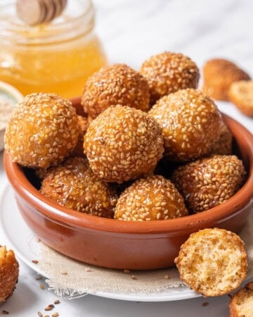 bowl of cheese puffs coated with honey.