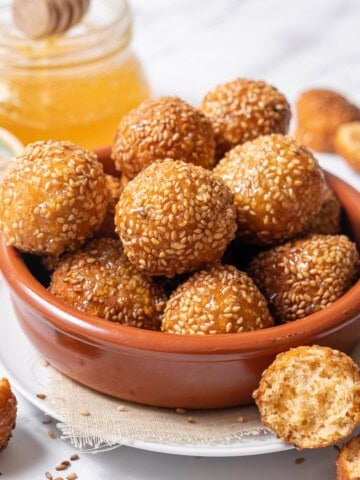 bowl of cheese puffs coated with honey.