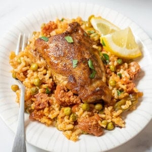 plate of chicken and chorizo rice with a fork.