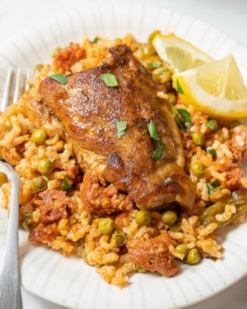 plate of chicken and chorizo rice with a fork.