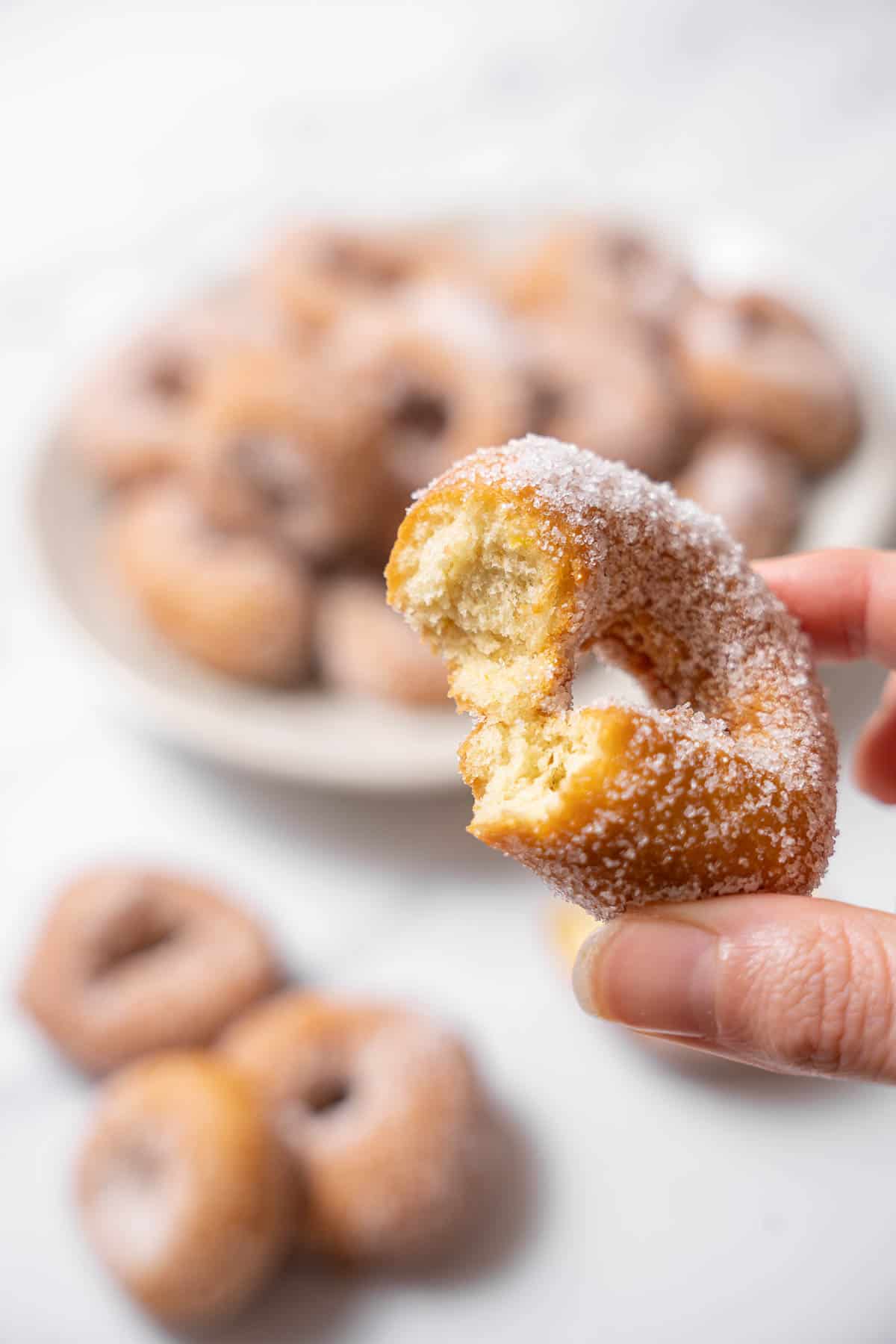 holding a fried donut.