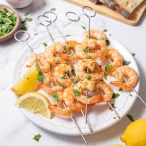 serving gambas al ajillo with lemon wedges.