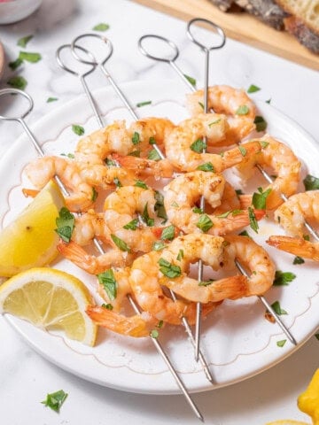 serving gambas al ajillo with lemon wedges.