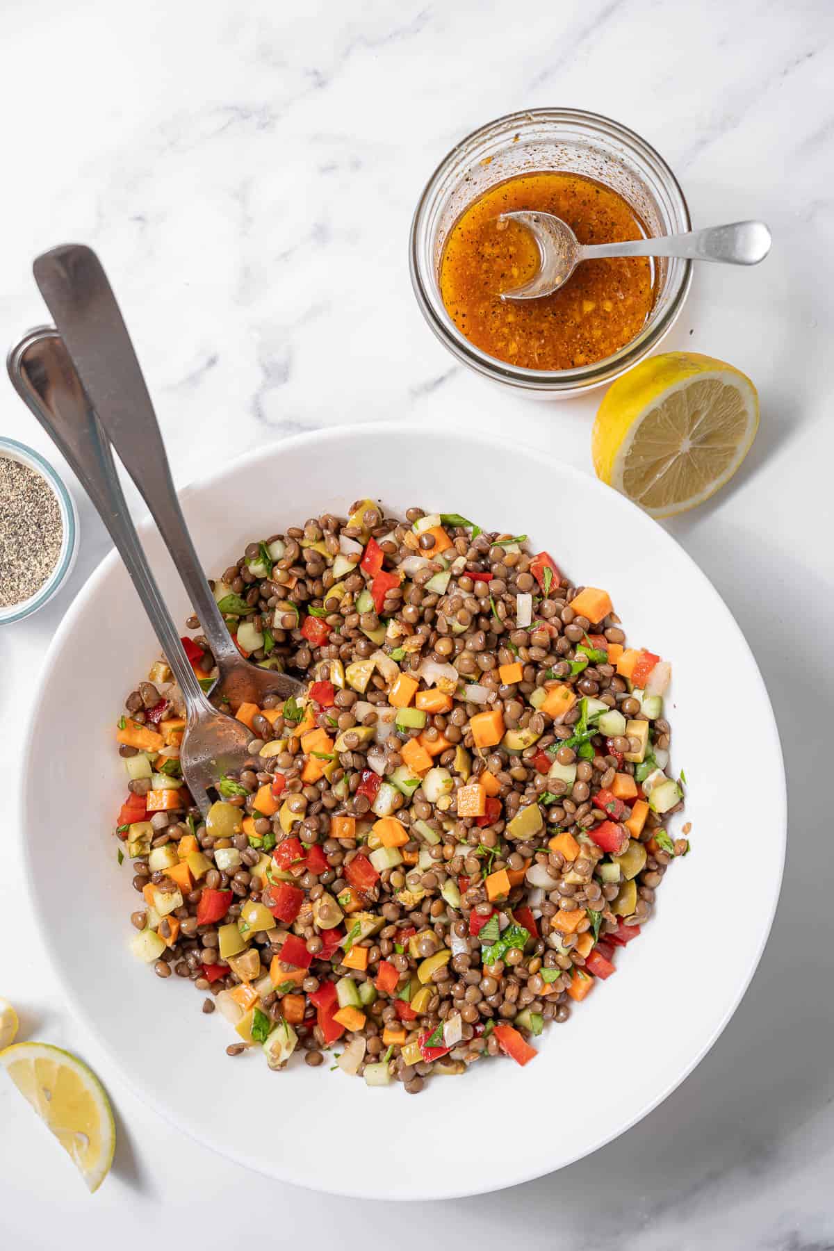 bowl of lentil salad with utensils.