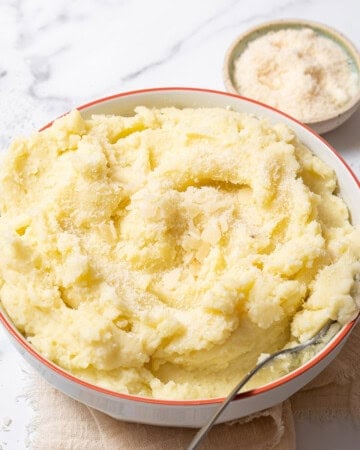 bowl of manchego mashed potatoes with a spoon.