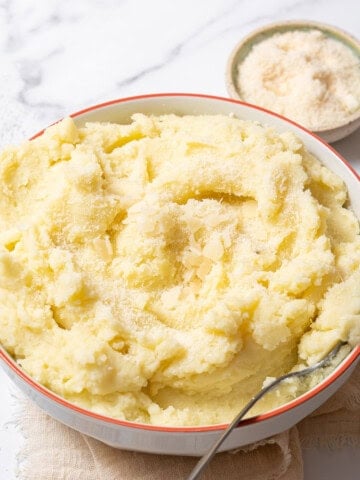 bowl of manchego mashed potatoes with a spoon.