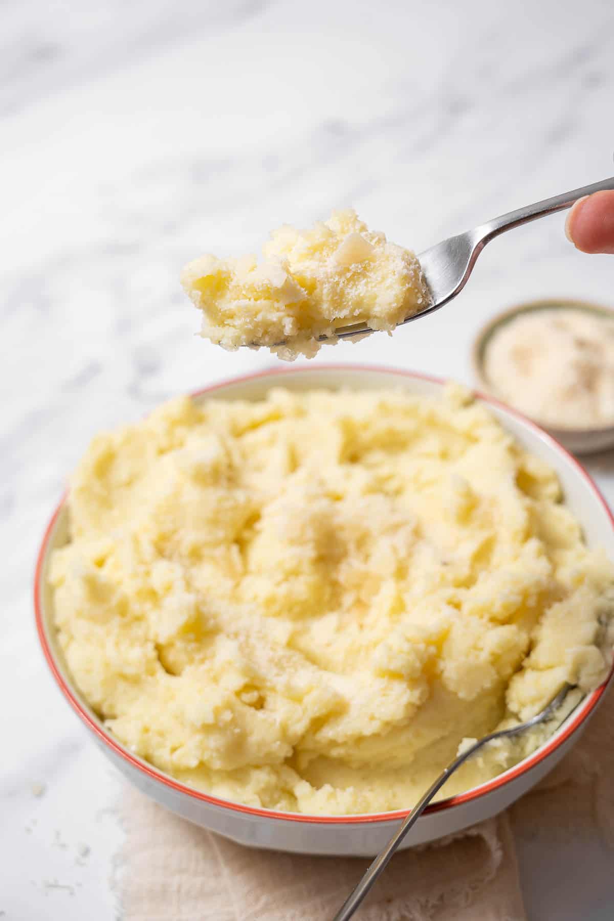 holding a forkful of manchego mashed potatoes.