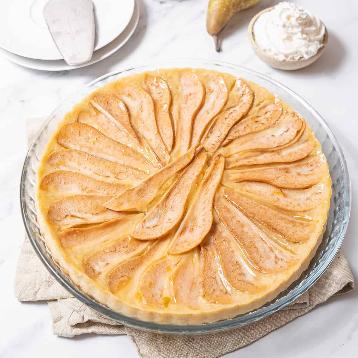 pear tart on a glass plate.