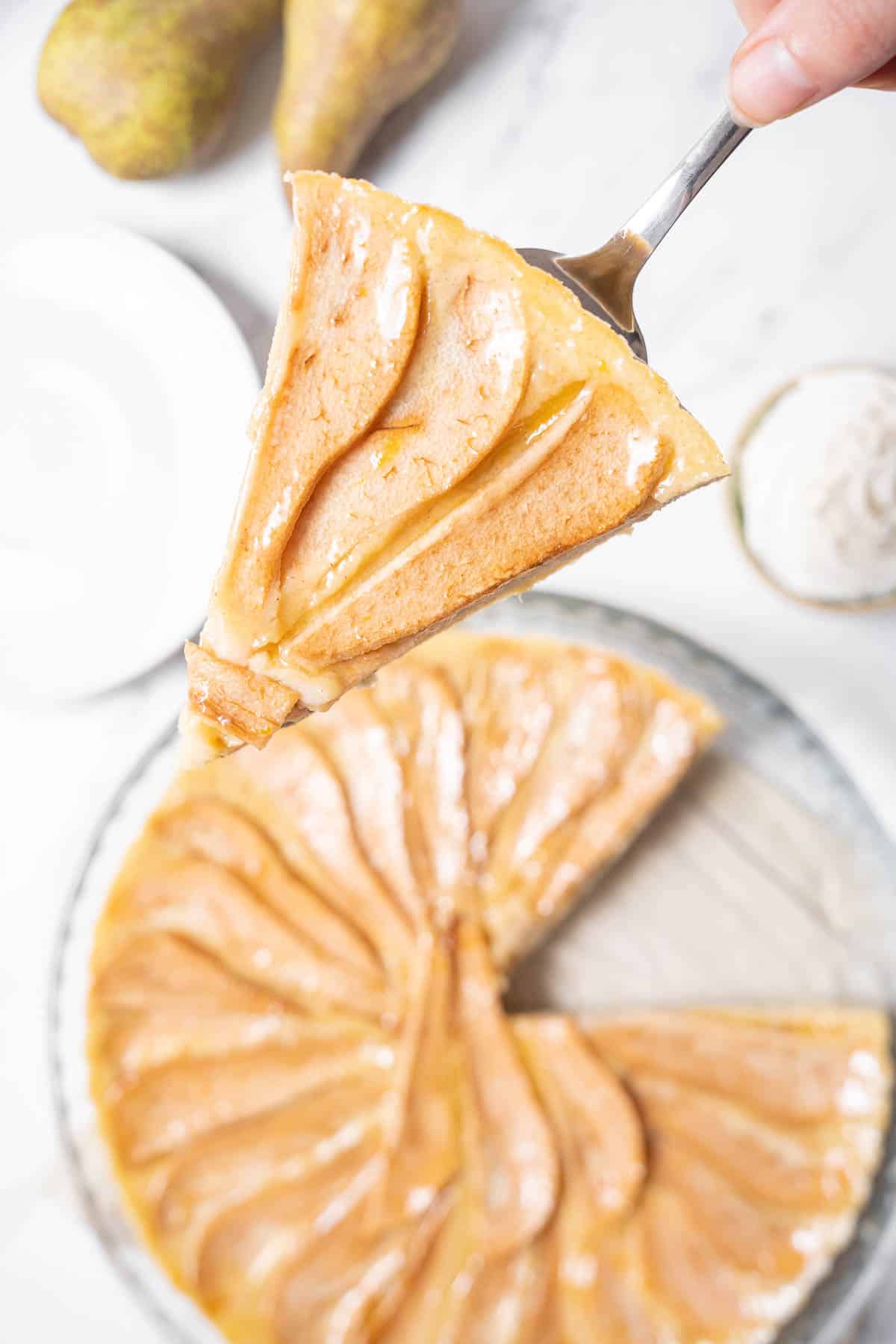 holding a slice of pear tart.