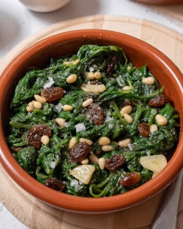 bowl of spinach with pine nuts.