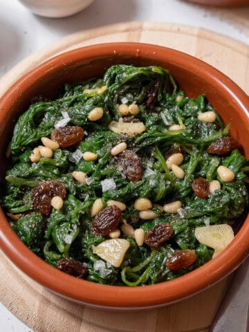 bowl of spinach with pine nuts.