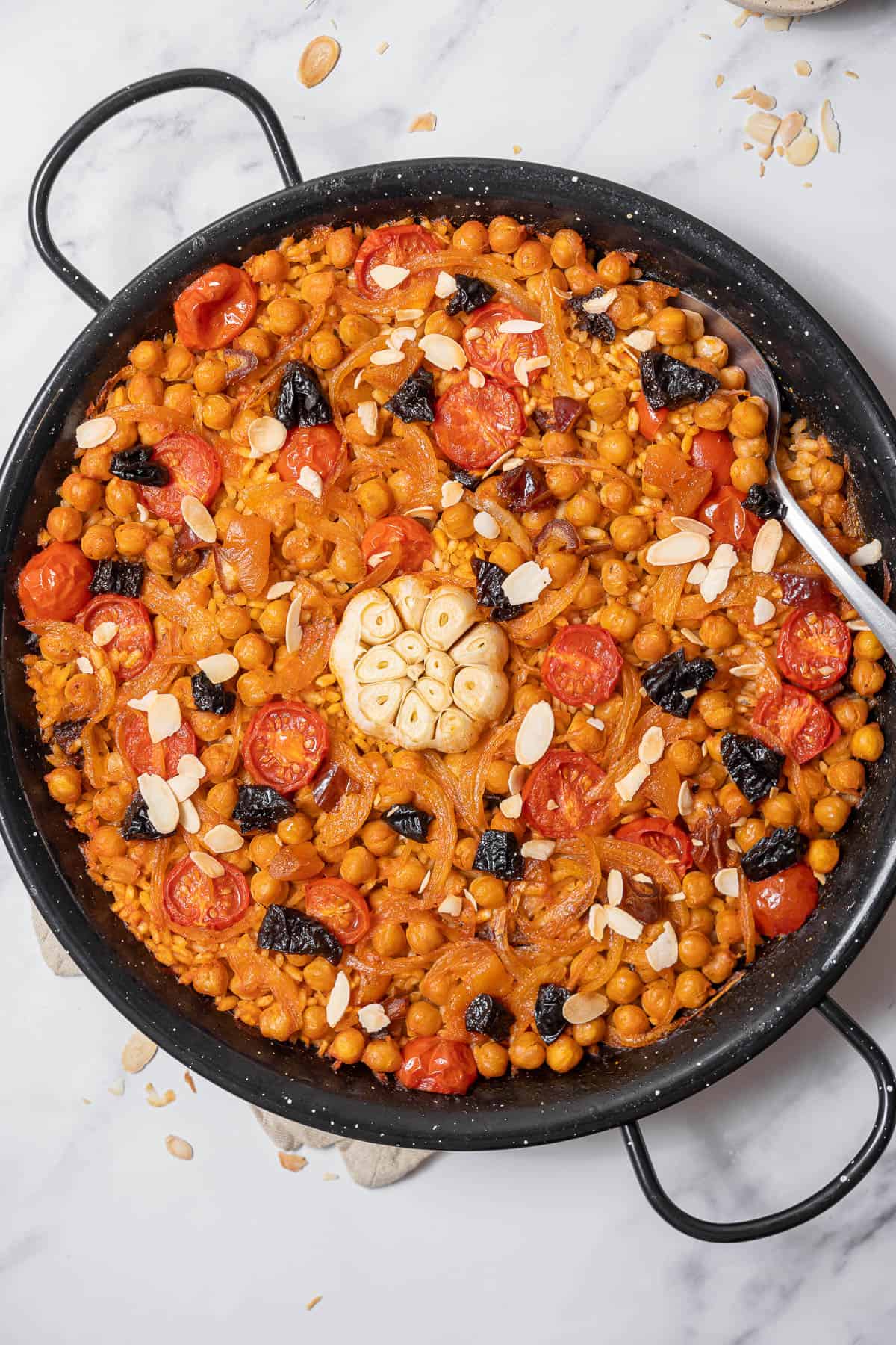 baked rice with garbanzos with a serving spoon.