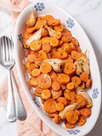 plate of roasted carrots with garlic.