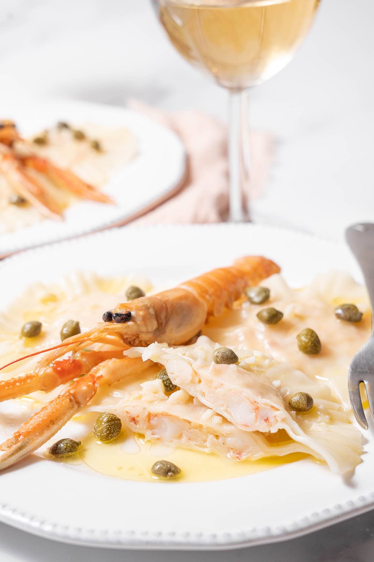 plate of langoustine ravioli with wine.