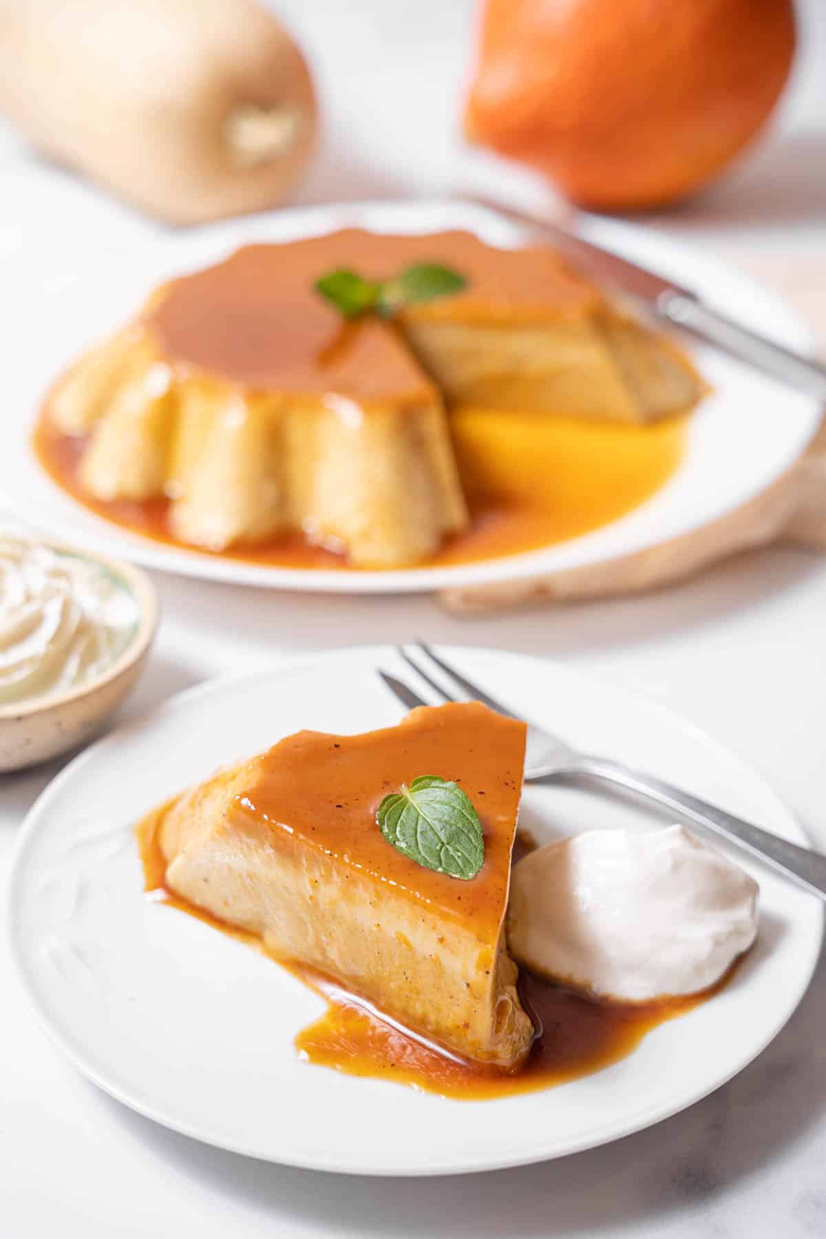 slice of pumpkin flan with whipped cream.